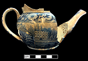 Pearlware teapot printed underglaze in medium blue.  Scene shows a shepherd and sheep in a country estate setting.   Continuous repeating floral border.  Transferware Collector’s Club named this pattern “Elegant Shepherd Boy”. 3.5” base diameter.
